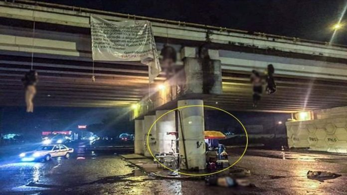 Normalización de la violencia; vendiendo hamburguesas pese a cuerpos colgados