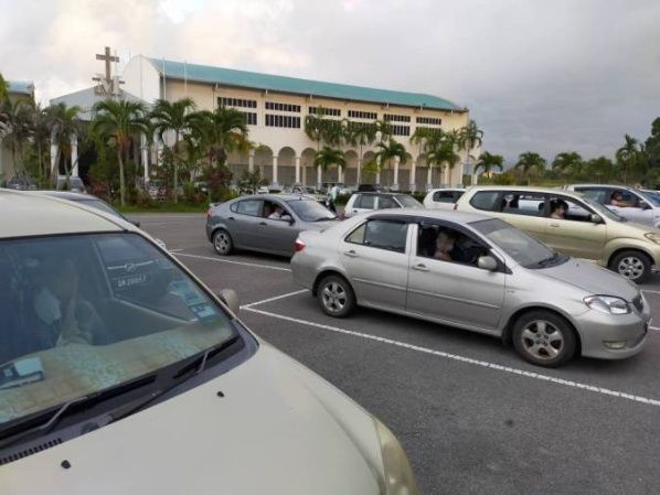Ofician misa en el estacionamiento de una iglesia