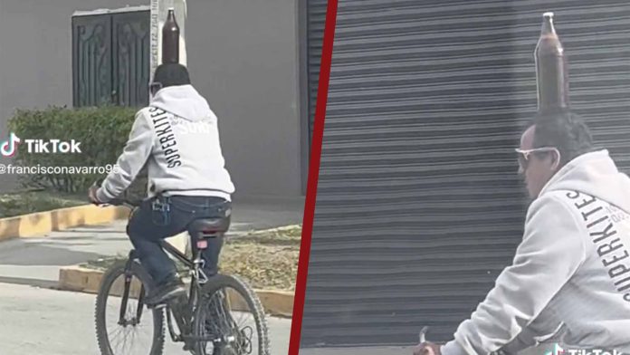 Hombre se viraliza por andar en bicicleta con una caguama en su cabeza