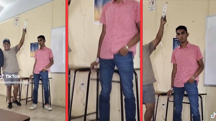 Estudiante expone en clase con todo y suero