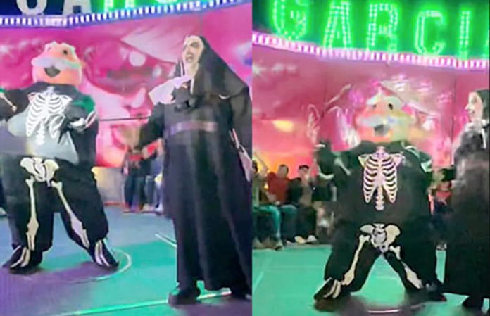 Dr. Simi y Monja de la Feria bailan en juego mecánico