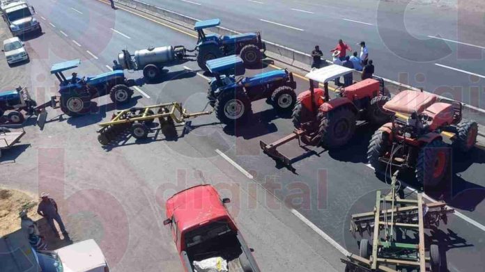 Campesinos bloquean con tractores la carretera Apatzingán-Cuatro Caminos